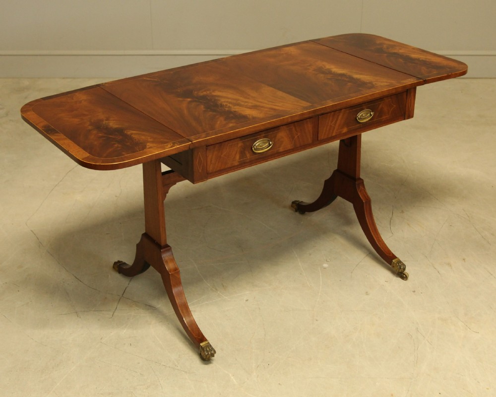 A 19th century curl mahogany sofa table