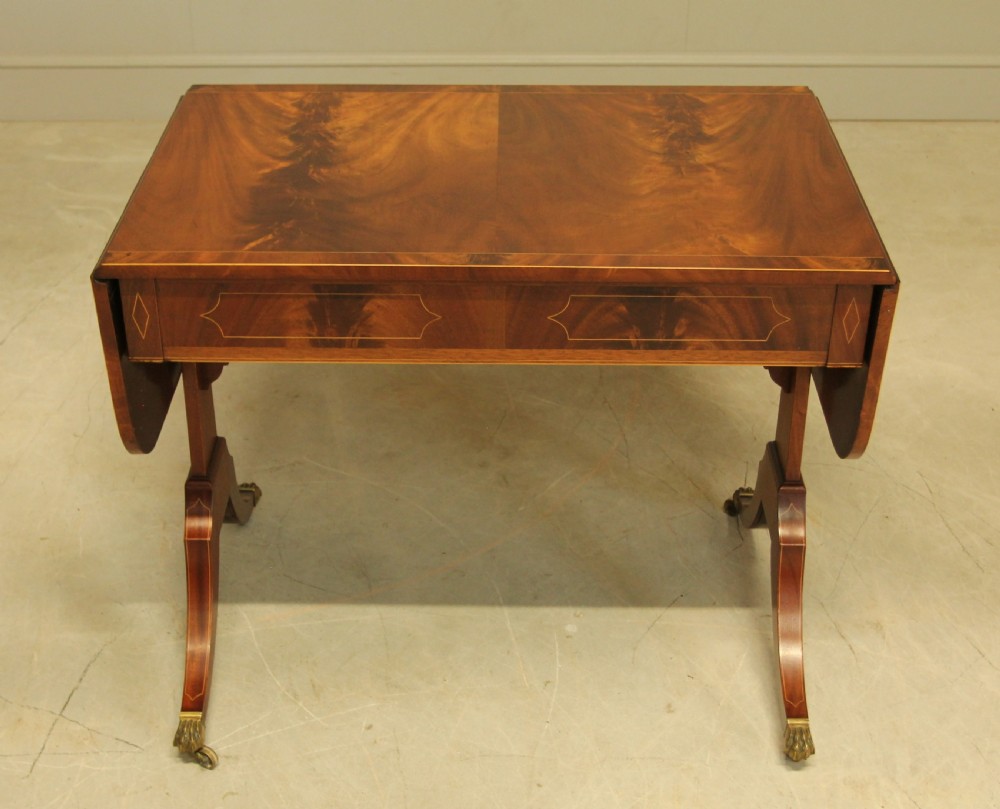 A 19th century curl mahogany sofa table View X