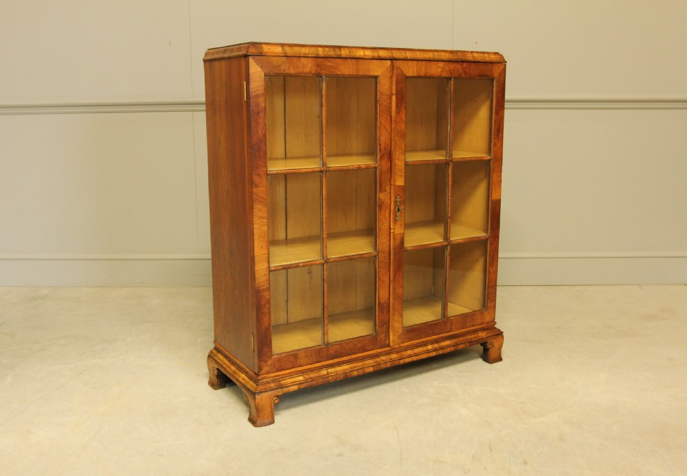 AN EARLY 20TH WALNUT DISPLAY BOOKCASE.