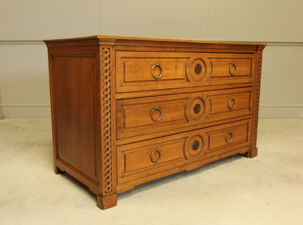 A 19TH CENTURY FRENCH OAK CHEST OF DRAWERS. View IV