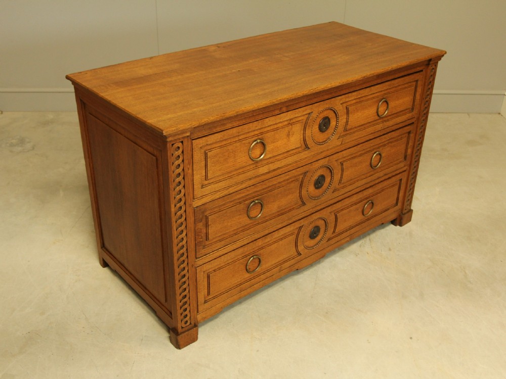 A 19TH CENTURY FRENCH OAK CHEST OF DRAWERS. View VI