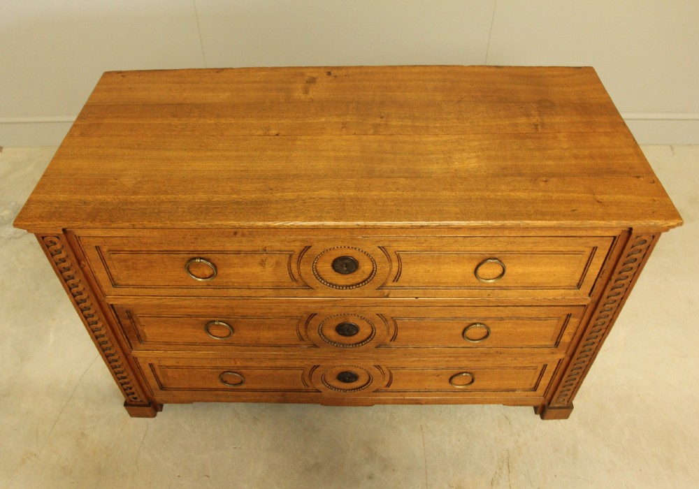 A 19TH CENTURY FRENCH OAK CHEST OF DRAWERS. View VII
