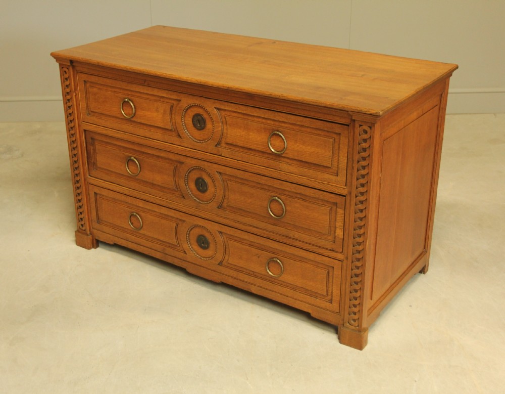 A 19TH CENTURY FRENCH OAK CHEST OF DRAWERS. View VIII