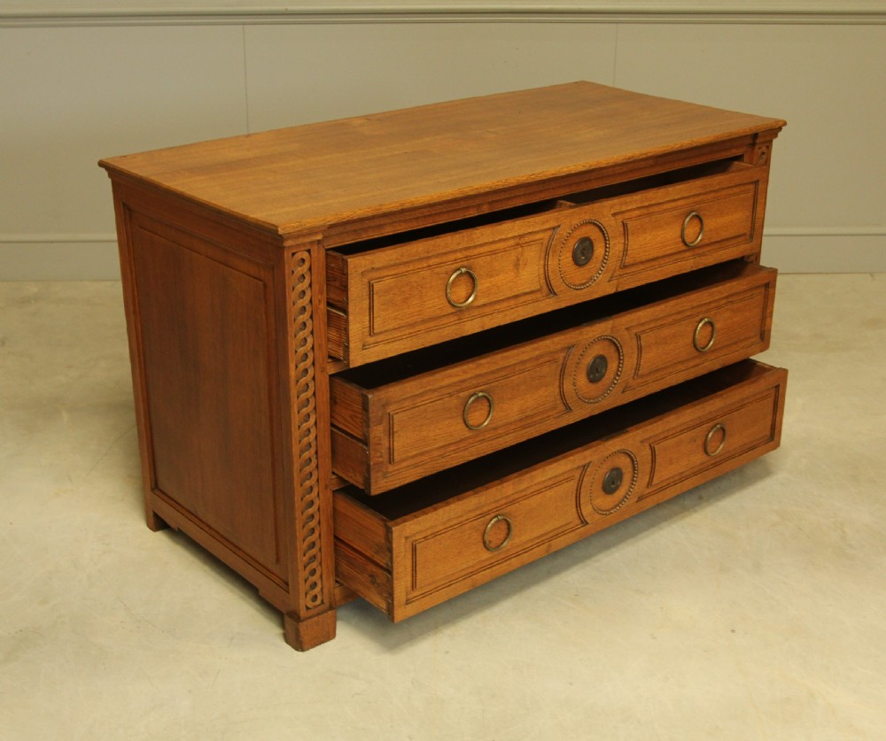 A 19TH CENTURY FRENCH OAK CHEST OF DRAWERS. View IX