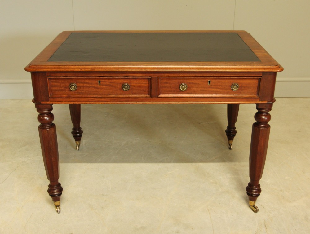 A Victorian mahogany writing table. 