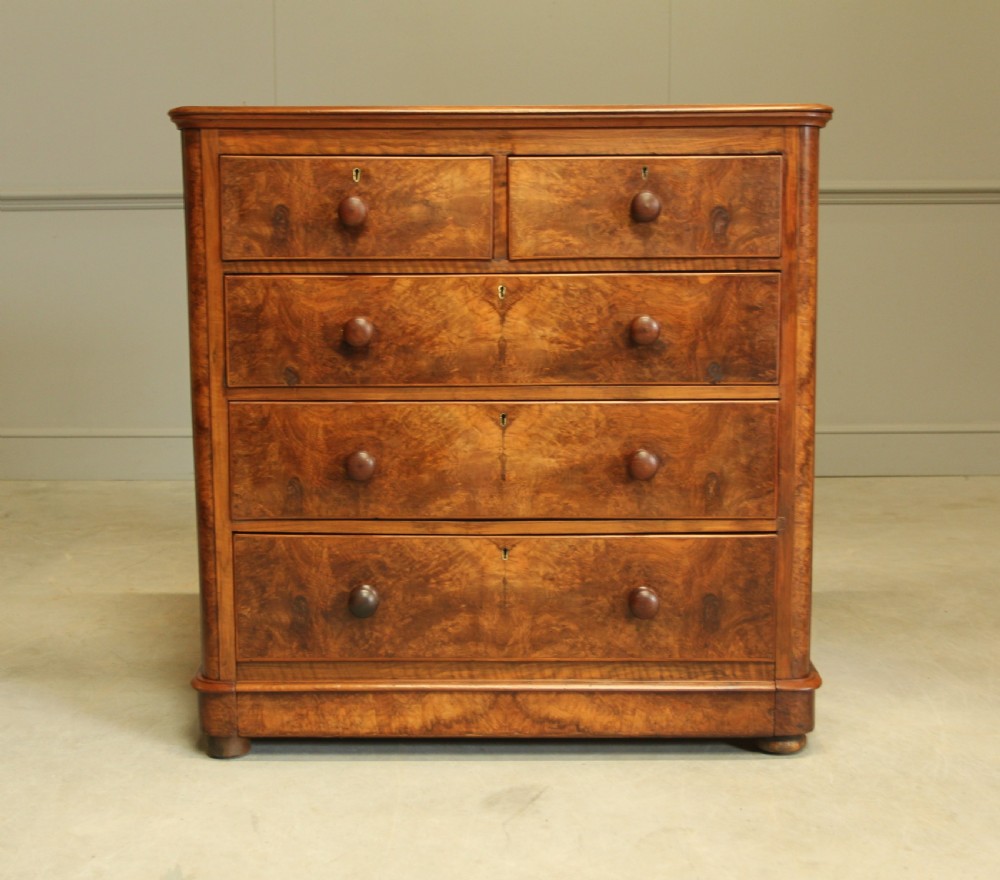 A VICTORIAN BURR WALNUT CHEST OF DRAWERS