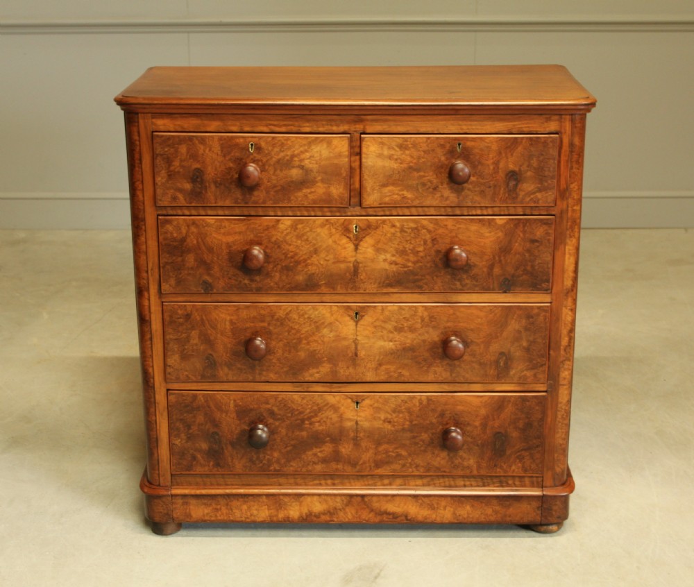 A VICTORIAN BURR WALNUT CHEST OF DRAWERS View II