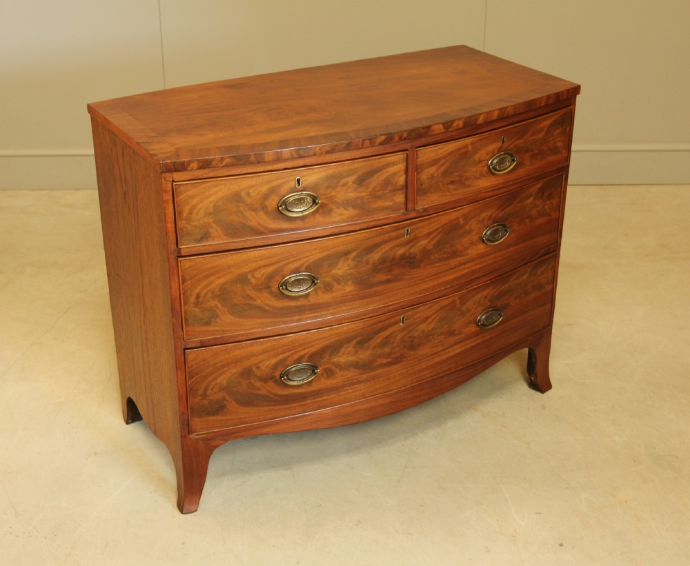 A REGENCY MAHOGANY BOW FRONTED CHEST OF DRAWERS. View VII