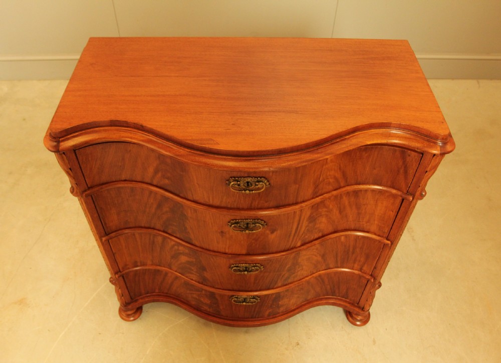 A 19th century Swedish serpentine chest of drawers. View III