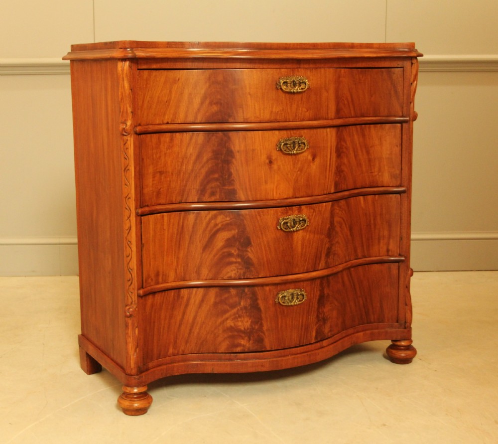 A 19th century Swedish serpentine chest of drawers. View VI