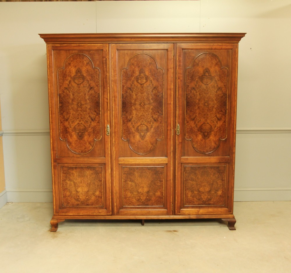 AN EARLY 20TH CENTURY BURR WALNUT TRIPLE WARDROBE