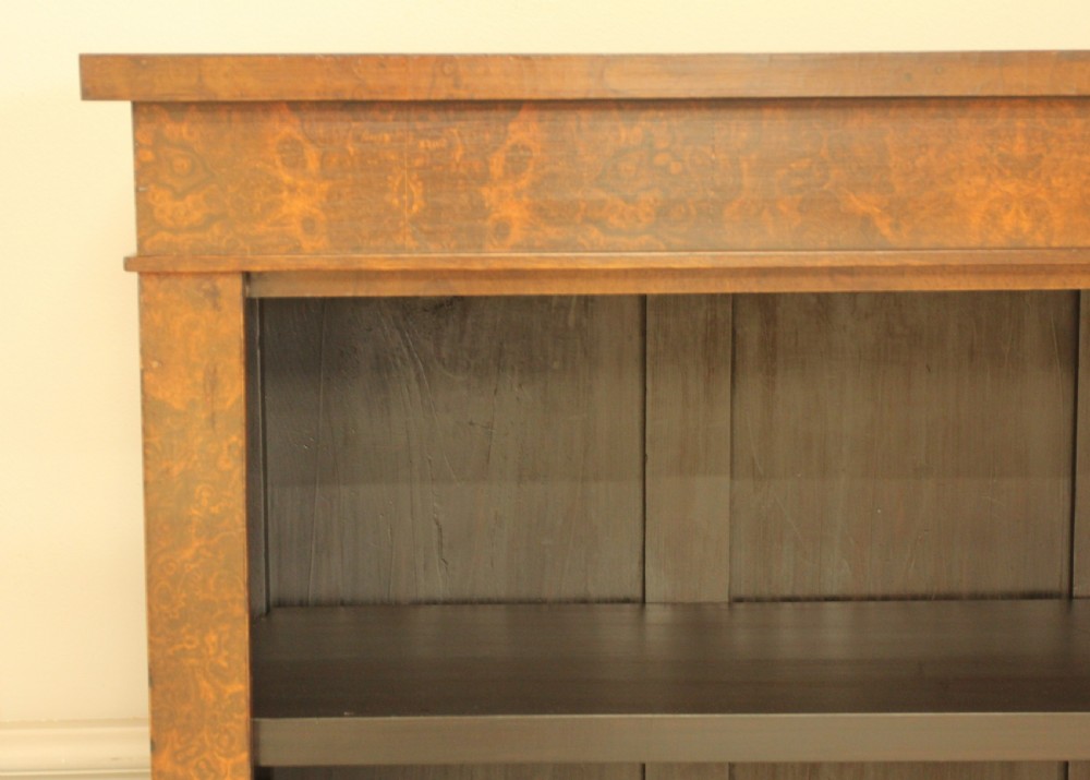 A Victorian open bookcase featuring faux burr walnut outer framing, dark interior shelves, and a solid plinth base. View II
