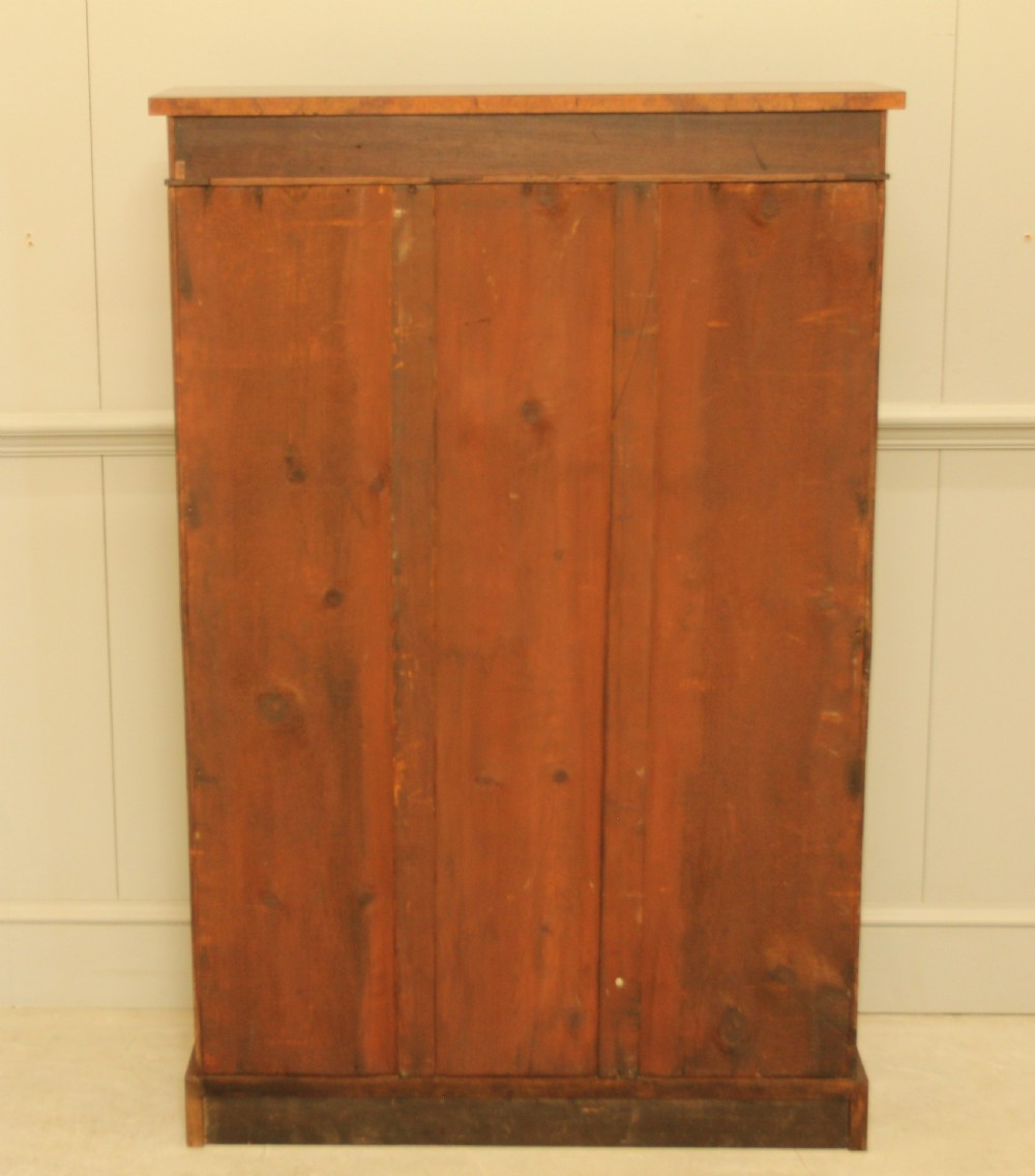 A Victorian open bookcase featuring faux burr walnut outer framing, dark interior shelves, and a solid plinth base. View X