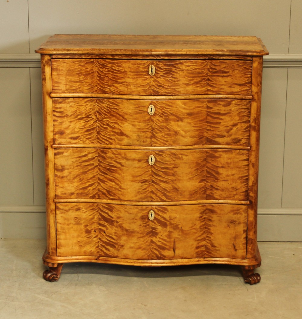 A 19th century Swedish serpentine chest of drawers.  View II