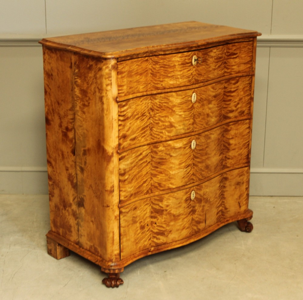 A 19th century Swedish serpentine chest of drawers.  View V