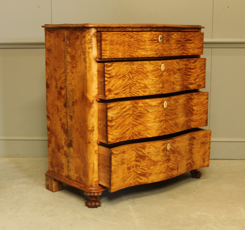 A 19th century Swedish serpentine chest of drawers.  View VI