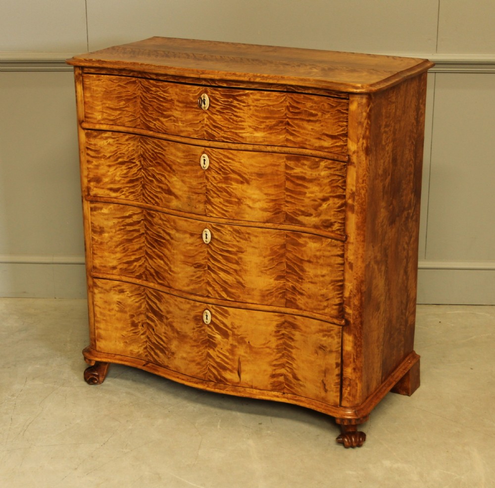 A 19th century Swedish serpentine chest of drawers.  View VIII