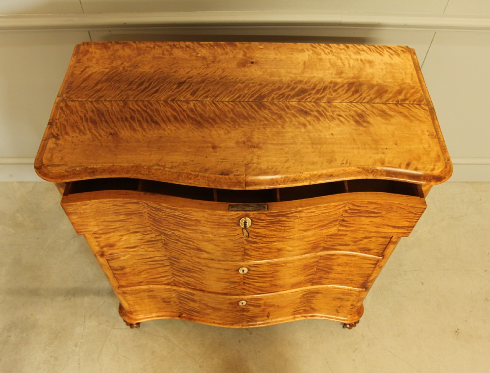 A 19th century Swedish serpentine chest of drawers.  View IX