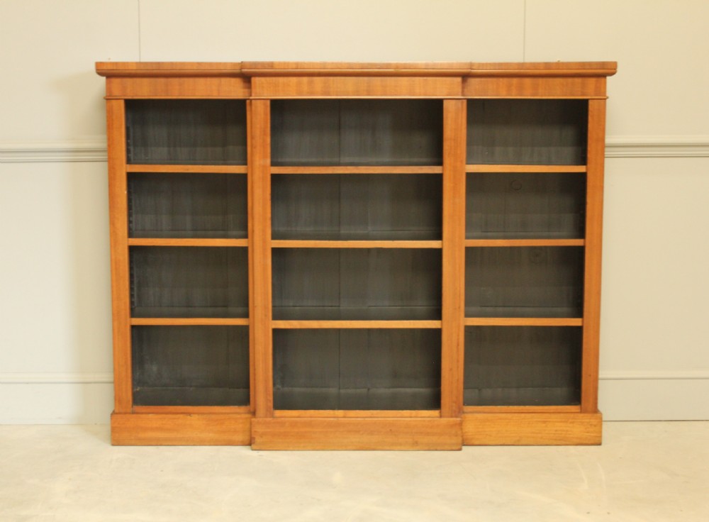 A low Victorian mahogany breakfront open bookcase featuring three sections with adjustable shelving on a solid plinth base. View IV