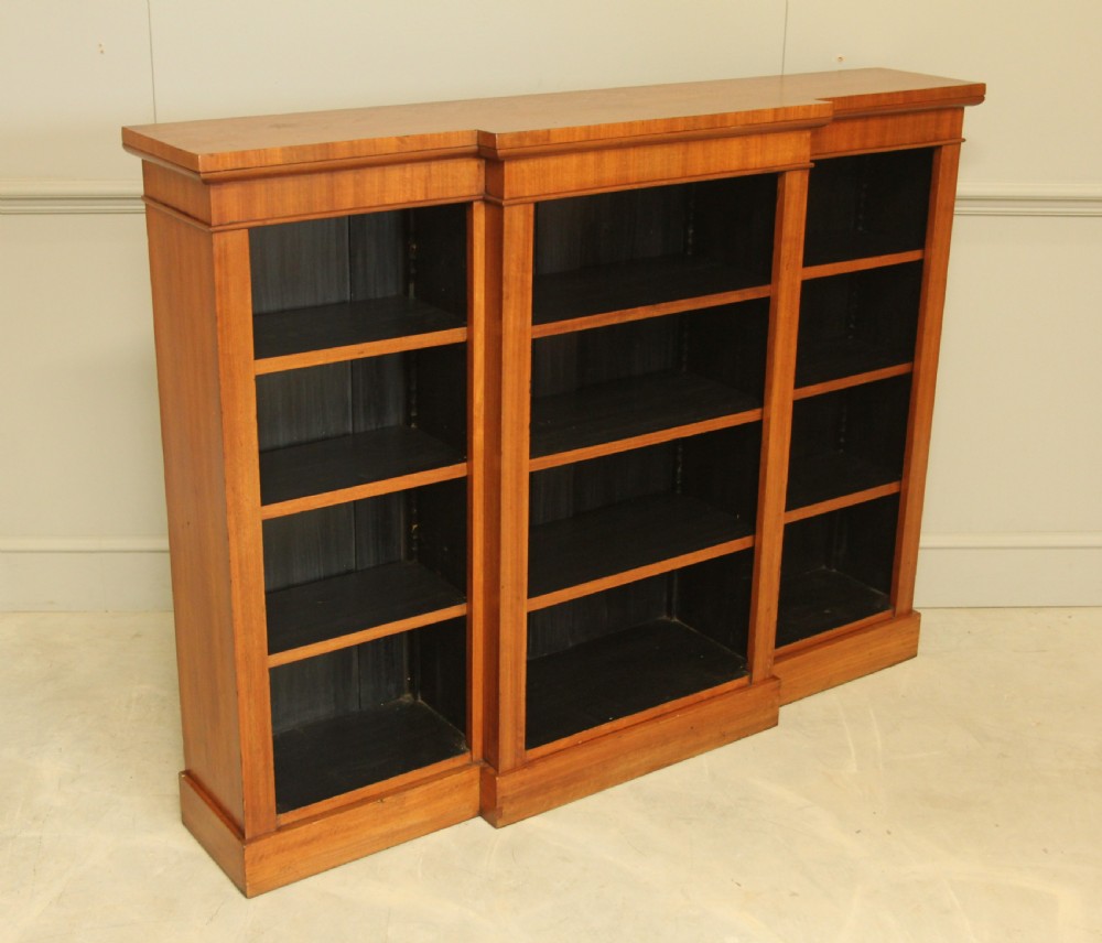 A low Victorian mahogany breakfront open bookcase featuring three sections with adjustable shelving on a solid plinth base. View VI