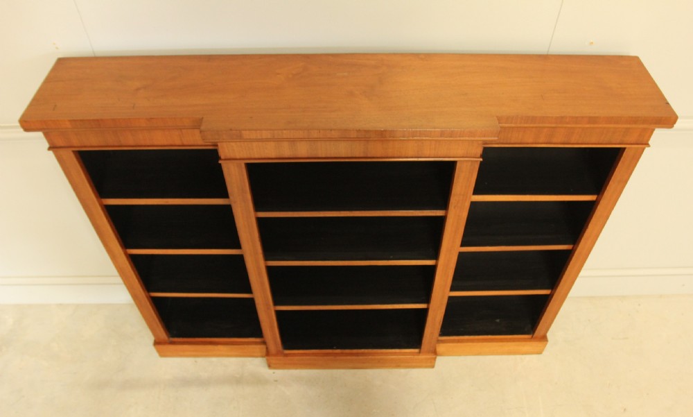 A low Victorian mahogany breakfront open bookcase featuring three sections with adjustable shelving on a solid plinth base. View VIII