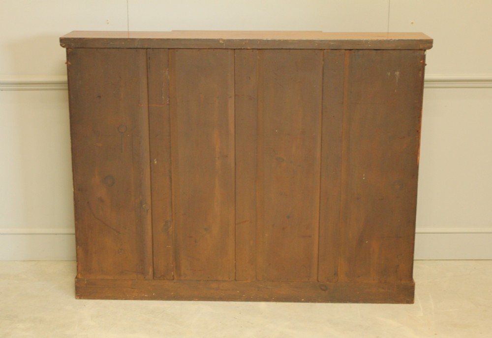 A low Victorian mahogany breakfront open bookcase featuring three sections with adjustable shelving on a solid plinth base. View IX