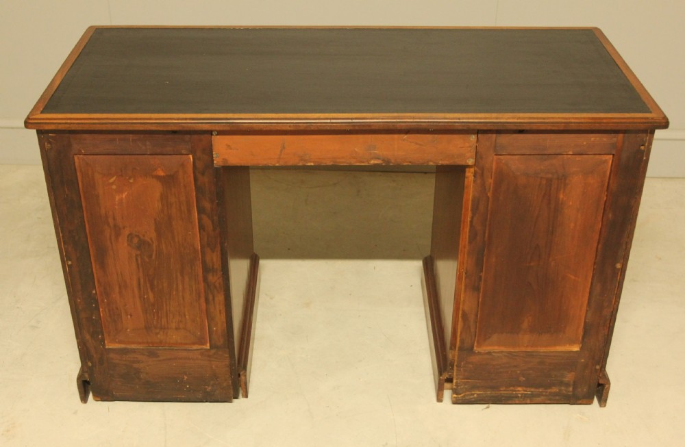 A Victorian mahogany pedestal desk featuring nine drawers with turned wooden handles and a dark leather inset writing surface. View XI