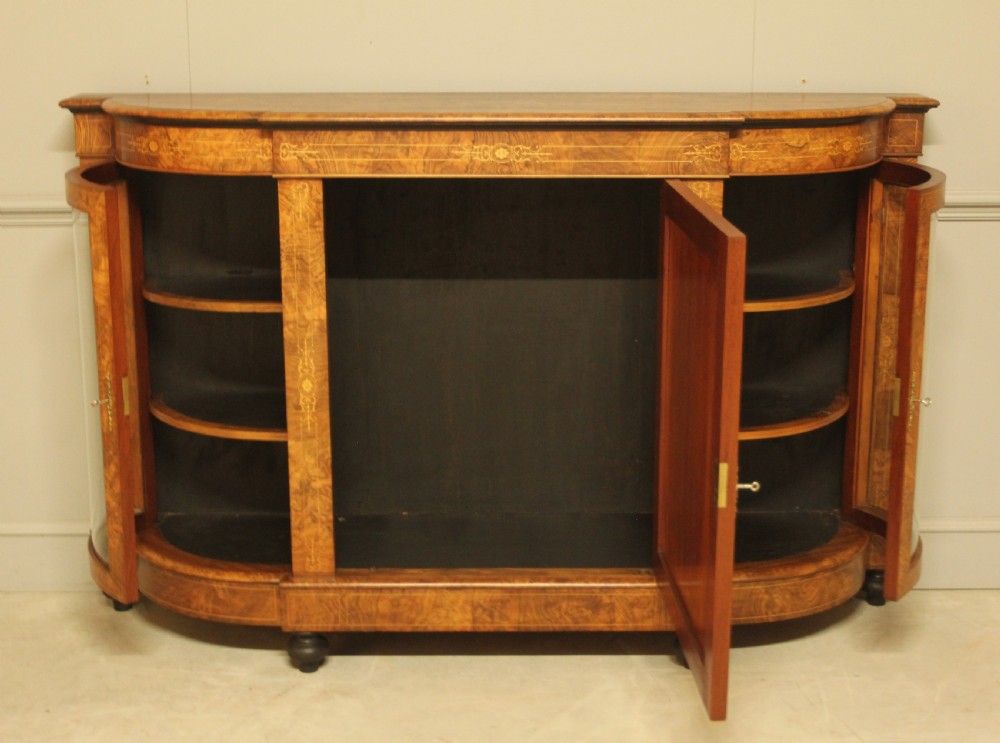 A Victorian burr walnut credenza featuring a central inlaid panel door flanked by two curved glass display doors with brass trim. View III