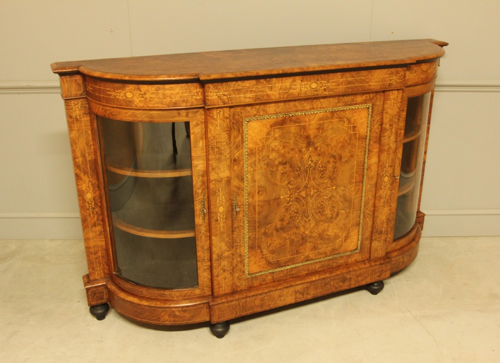 A Victorian burr walnut credenza featuring a central inlaid panel door flanked by two curved glass display doors with brass trim. View X