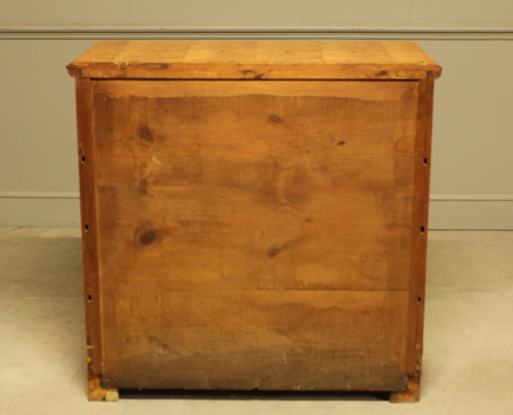 A nineteenth-century Swedish chest of drawers featuring four drawers crafted from light golden masur birch with dark keyhole escutcheons. View XI