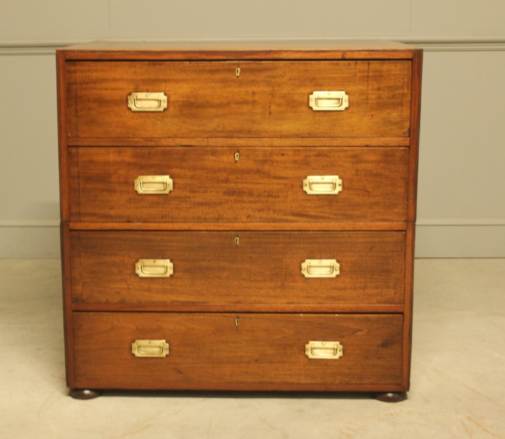 An early twentieth-century mahogany campaign chest featuring four full-width drawers with flush recessed brass handles.