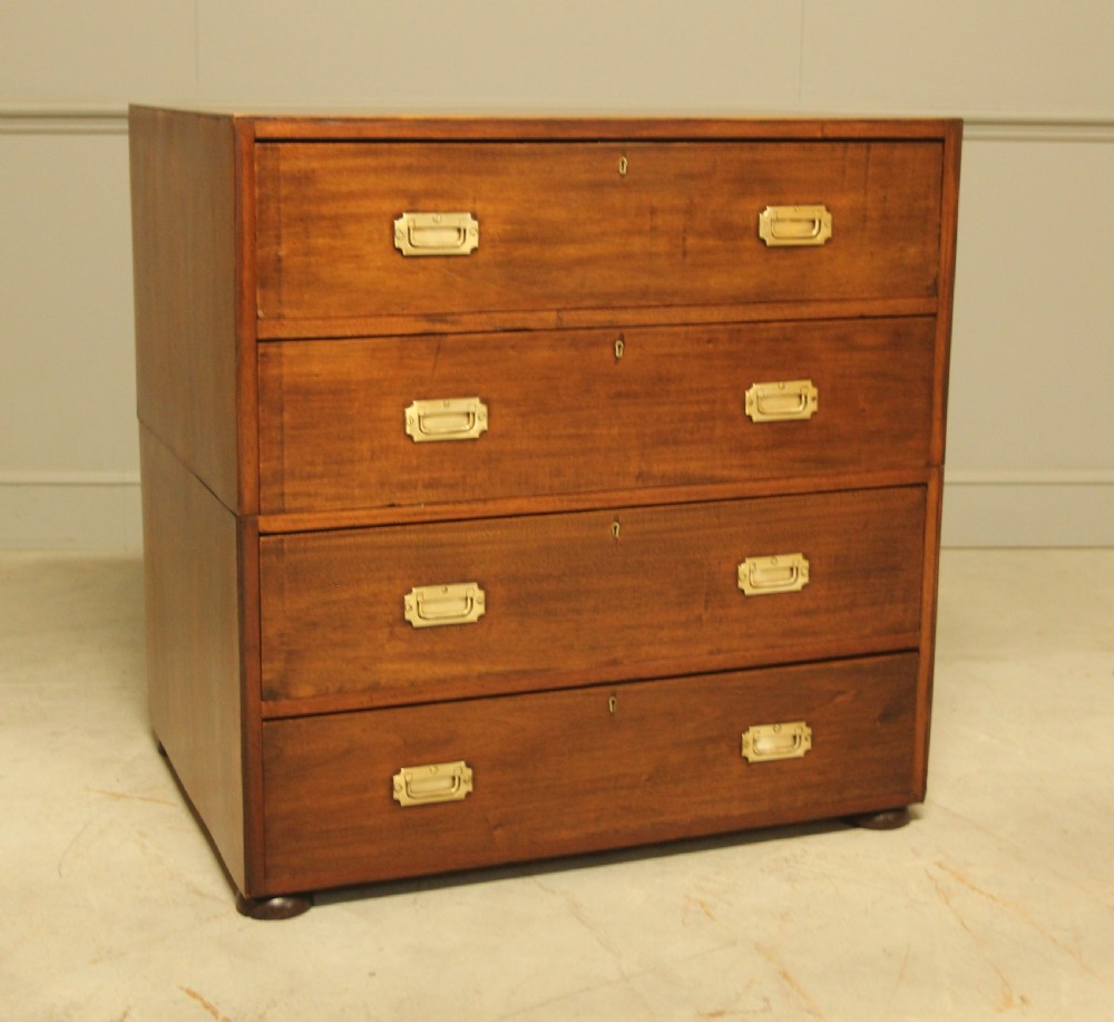 An early twentieth-century mahogany campaign chest featuring four full-width drawers with flush recessed brass handles. View V