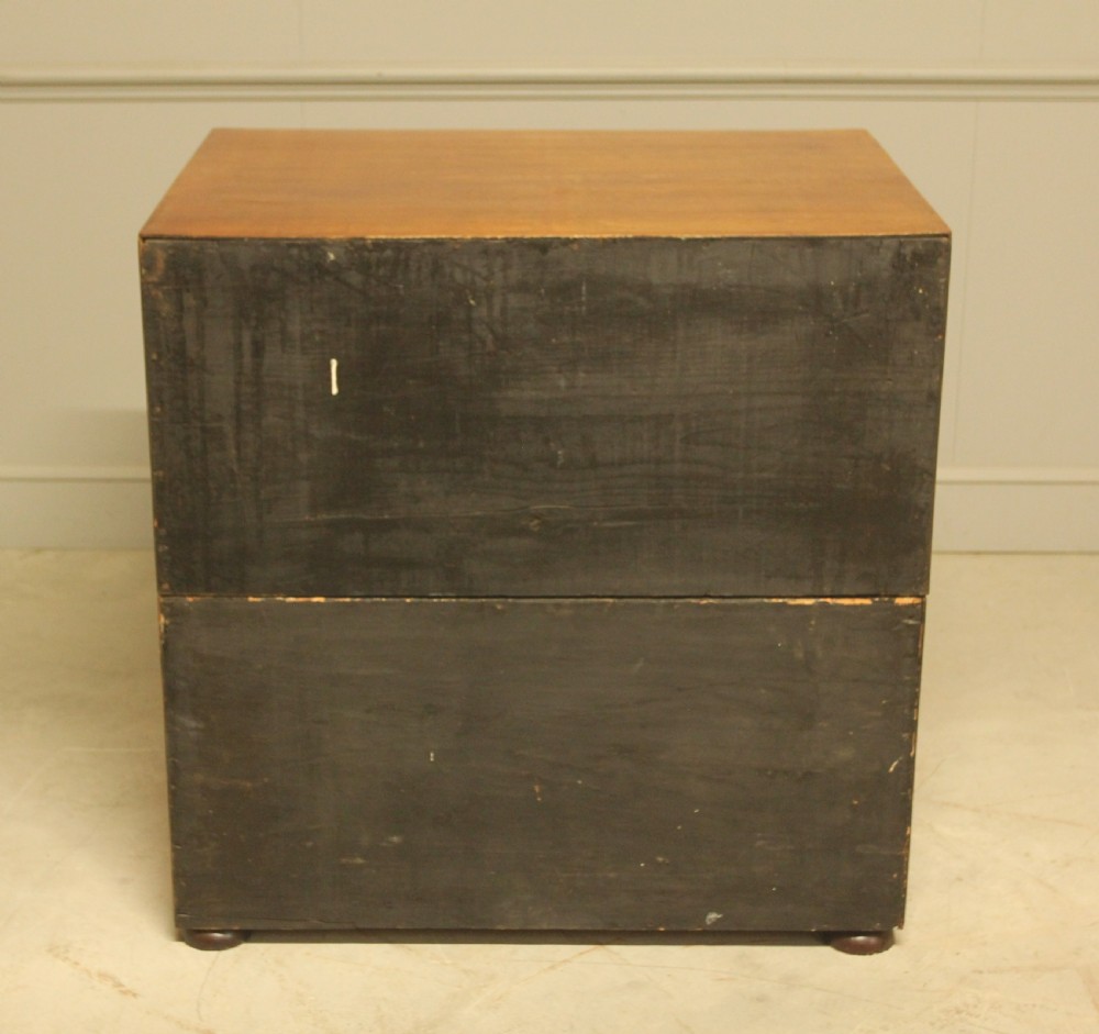An early twentieth-century mahogany campaign chest featuring four full-width drawers with flush recessed brass handles. View X