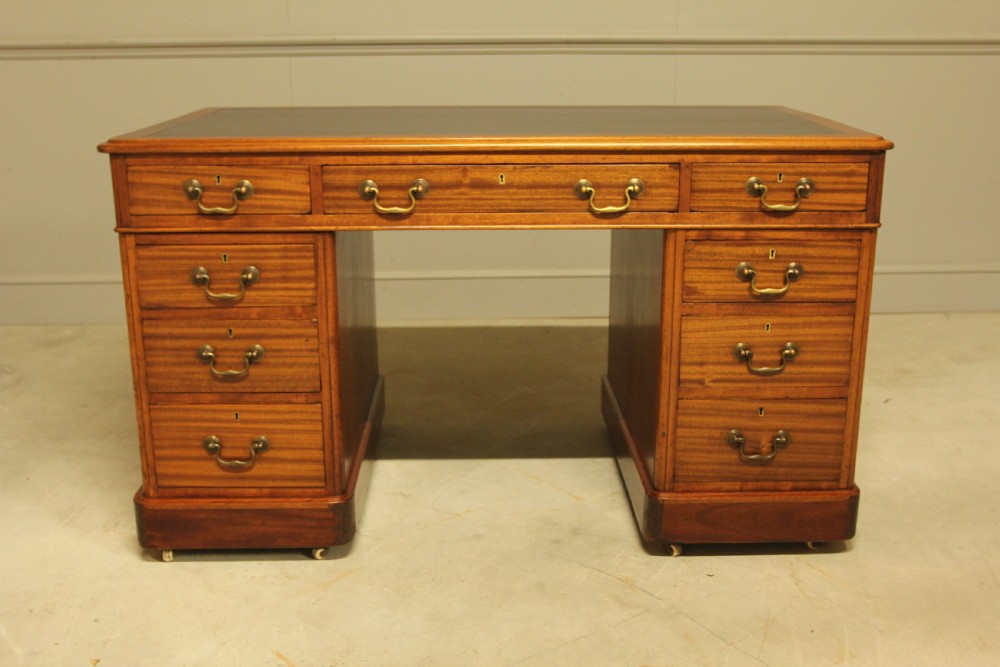 An early 20th-century mahogany twin-pedestal writing desk