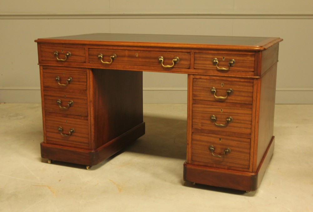 An early 20th-century mahogany twin-pedestal writing desk View XI