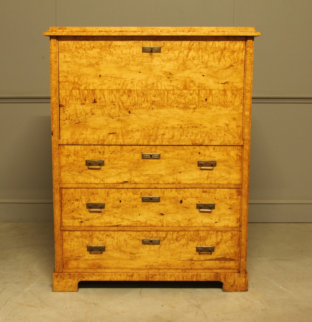 A 19th-century Swedish Masur birch secretaire desk featuring a fall-front top compartment above three wide drawers with brass handles. View II