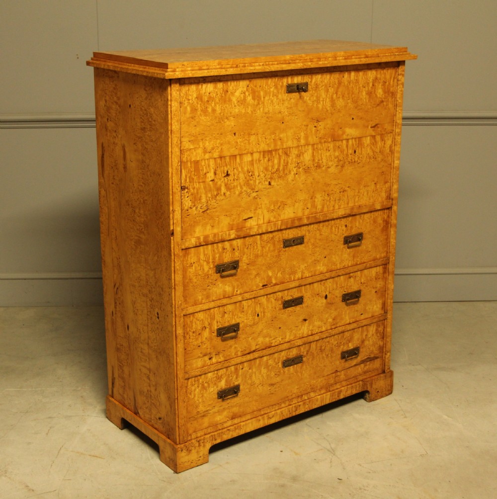 A 19th-century Swedish Masur birch secretaire desk featuring a fall-front top compartment above three wide drawers with brass handles. View III