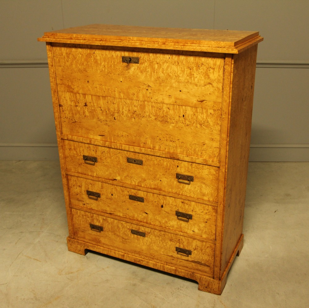 A 19th-century Swedish Masur birch secretaire desk featuring a fall-front top compartment above three wide drawers with brass handles. View IV