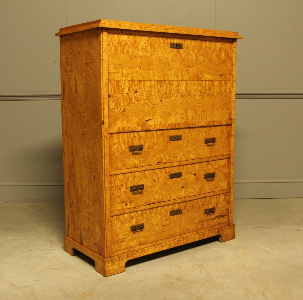 A 19th-century Swedish Masur birch secretaire desk featuring a fall-front top compartment above three wide drawers with brass handles. View V