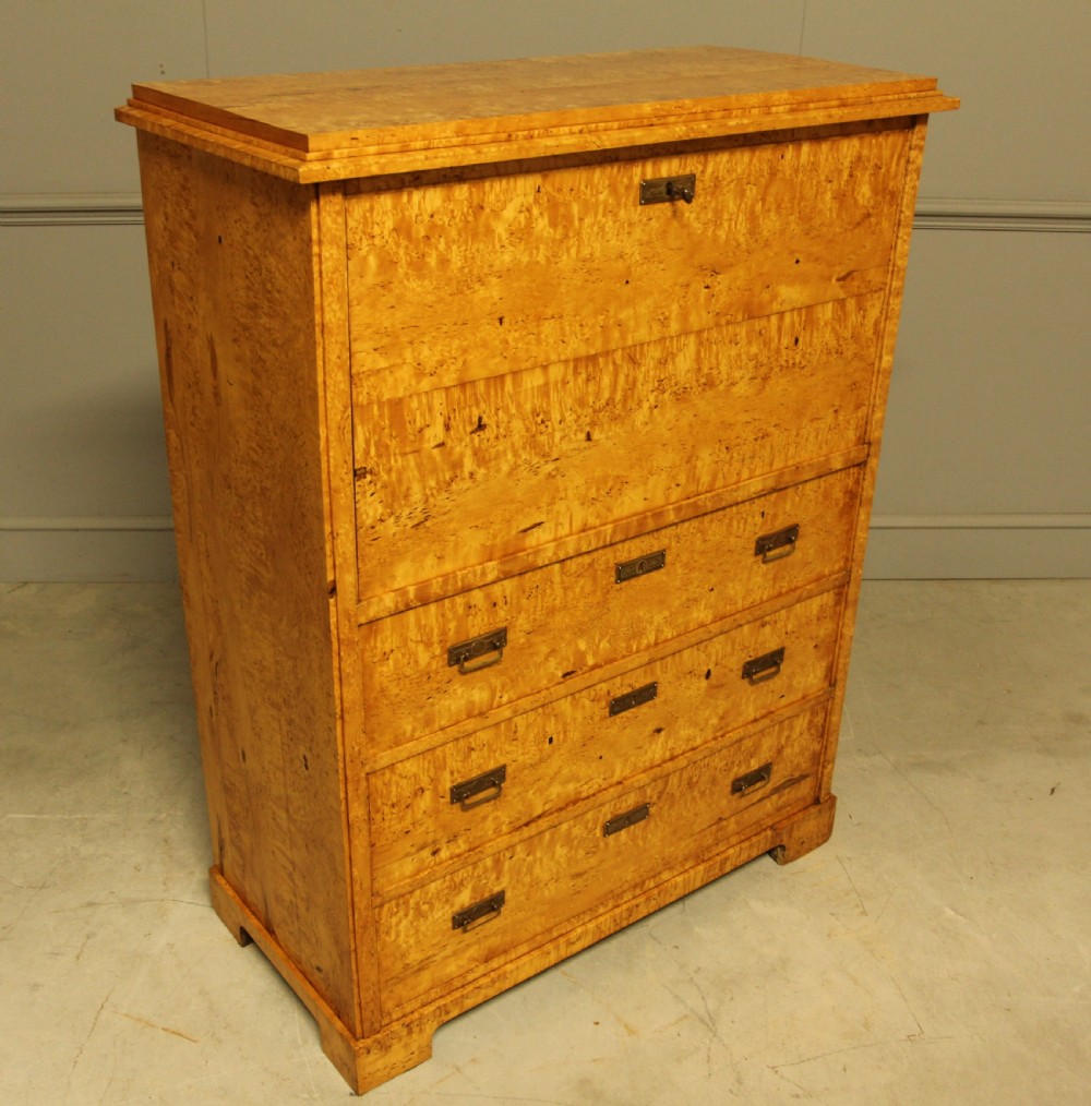 A 19th-century Swedish Masur birch secretaire desk featuring a fall-front top compartment above three wide drawers with brass handles. View VII
