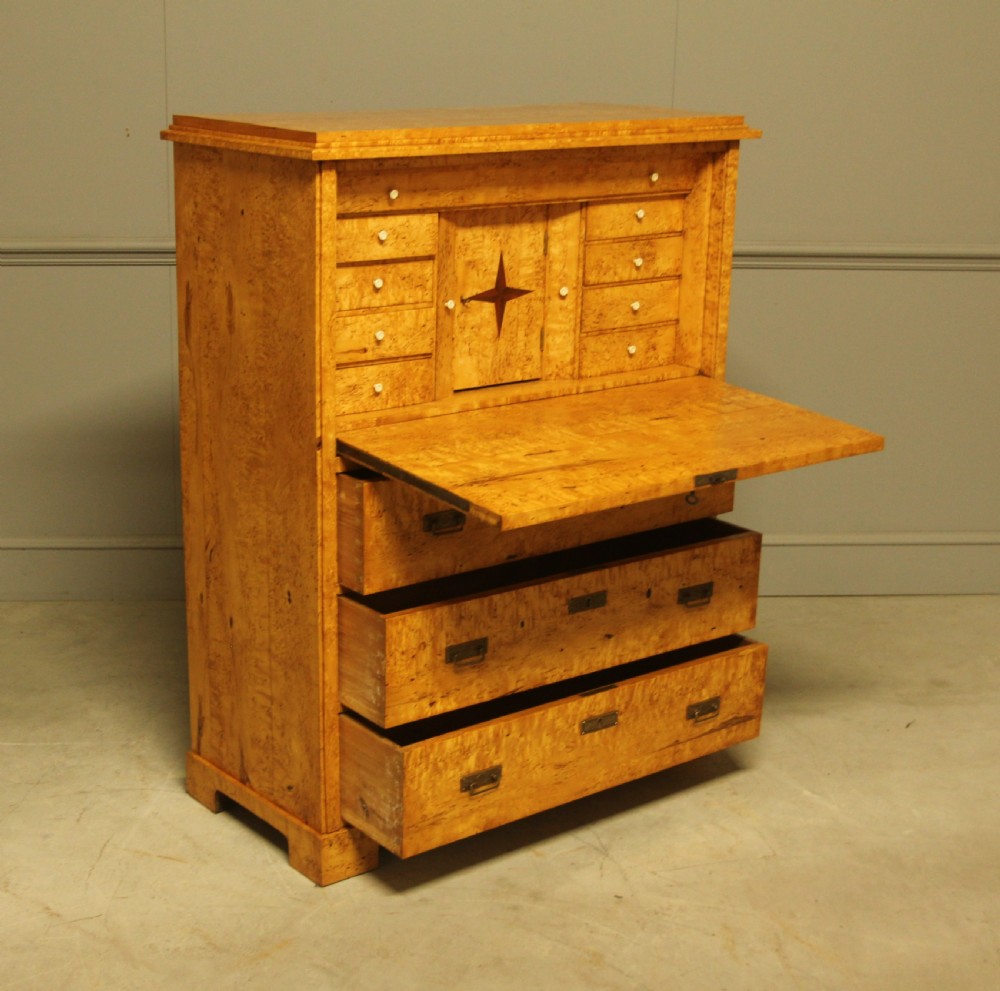 A 19th-century Swedish Masur birch secretaire desk featuring a fall-front top compartment above three wide drawers with brass handles. View XII