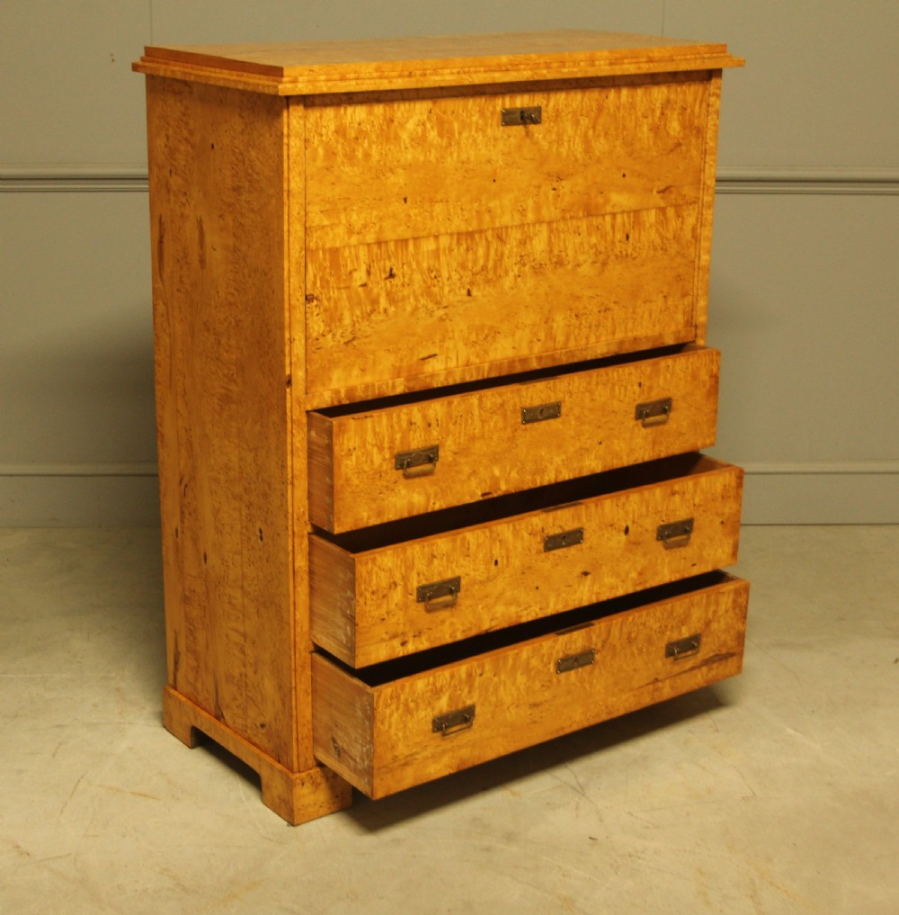 A 19th-century Swedish Masur birch secretaire desk featuring a fall-front top compartment above three wide drawers with brass handles. View XIII