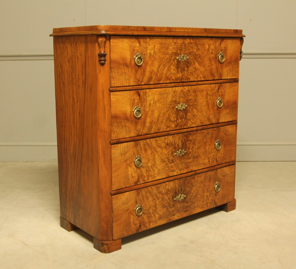 A late nineteenth-century Swedish burr walnut chest of drawers with four full-width drawers and brass handles.