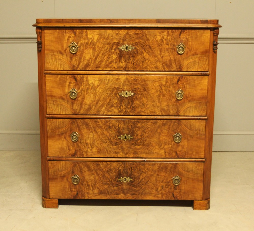 A late nineteenth-century Swedish burr walnut chest of drawers with four full-width drawers and brass handles. View II