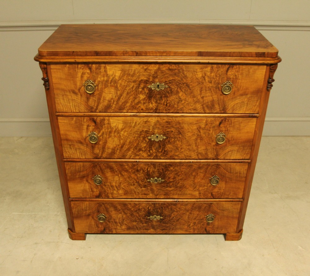 A late nineteenth-century Swedish burr walnut chest of drawers with four full-width drawers and brass handles. View III