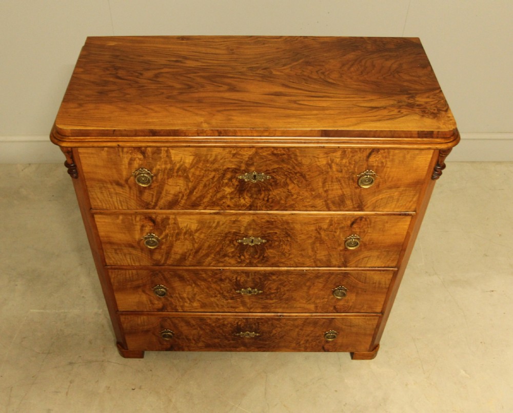 A late nineteenth-century Swedish burr walnut chest of drawers with four full-width drawers and brass handles. View IV