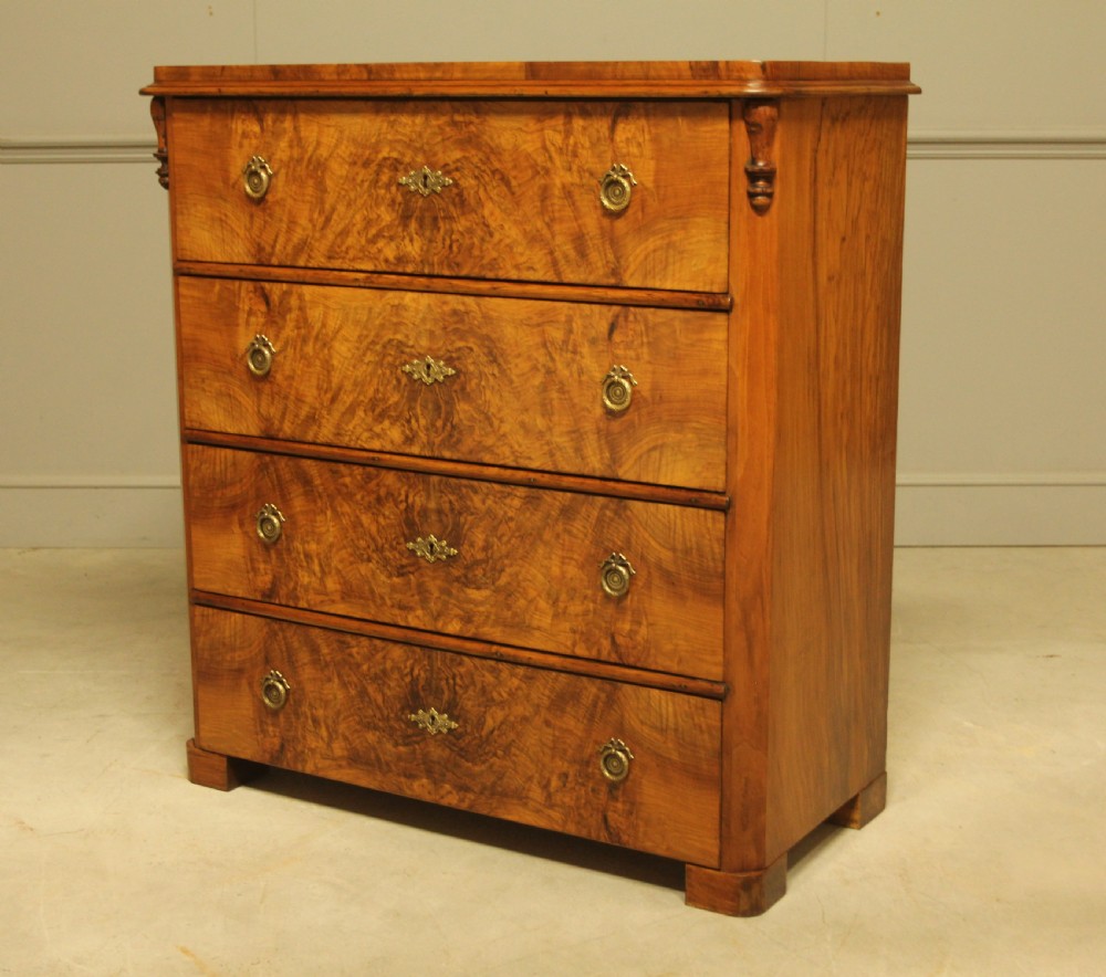 A late nineteenth-century Swedish burr walnut chest of drawers with four full-width drawers and brass handles. View VI