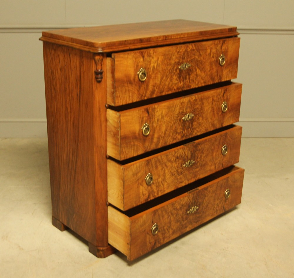 A late nineteenth-century Swedish burr walnut chest of drawers with four full-width drawers and brass handles. View VII
