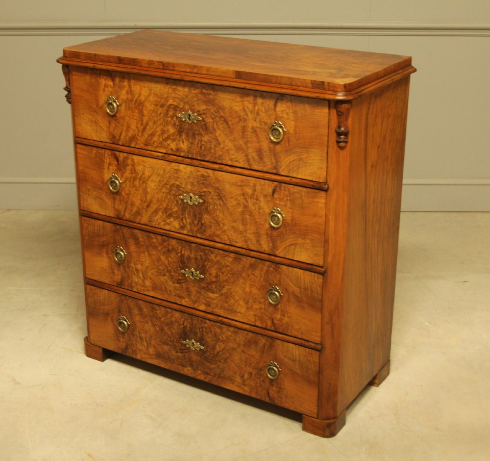 A late nineteenth-century Swedish burr walnut chest of drawers with four full-width drawers and brass handles. View VIII