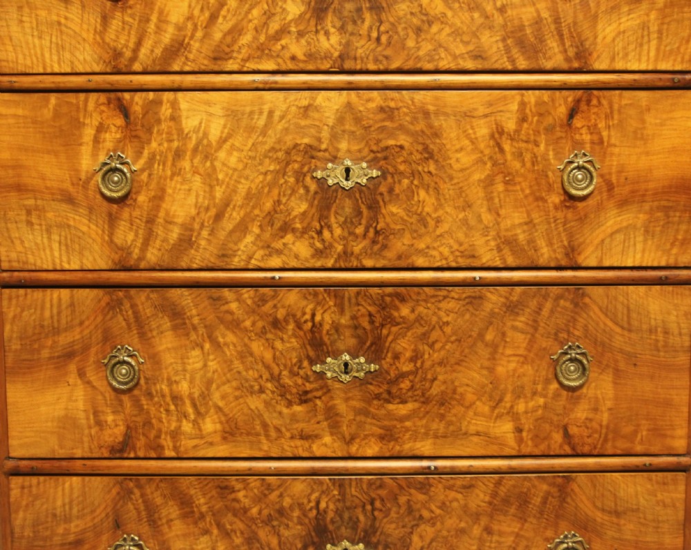 A late nineteenth-century Swedish burr walnut chest of drawers with four full-width drawers and brass handles. View IX